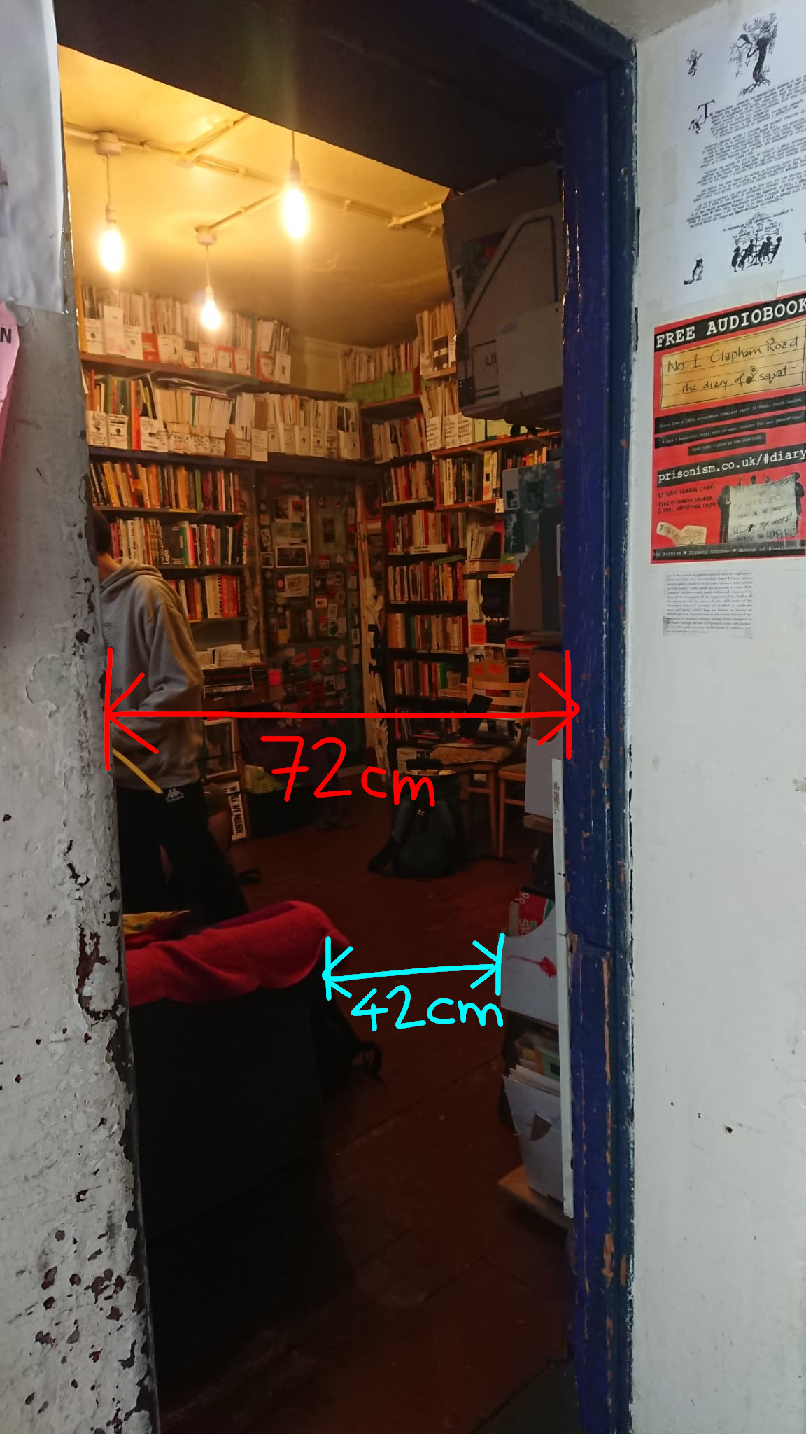 A photo of the third doorway, with a measurement of 72cm and a second measurement of 42cm between a sofa arm and a bookshelf
